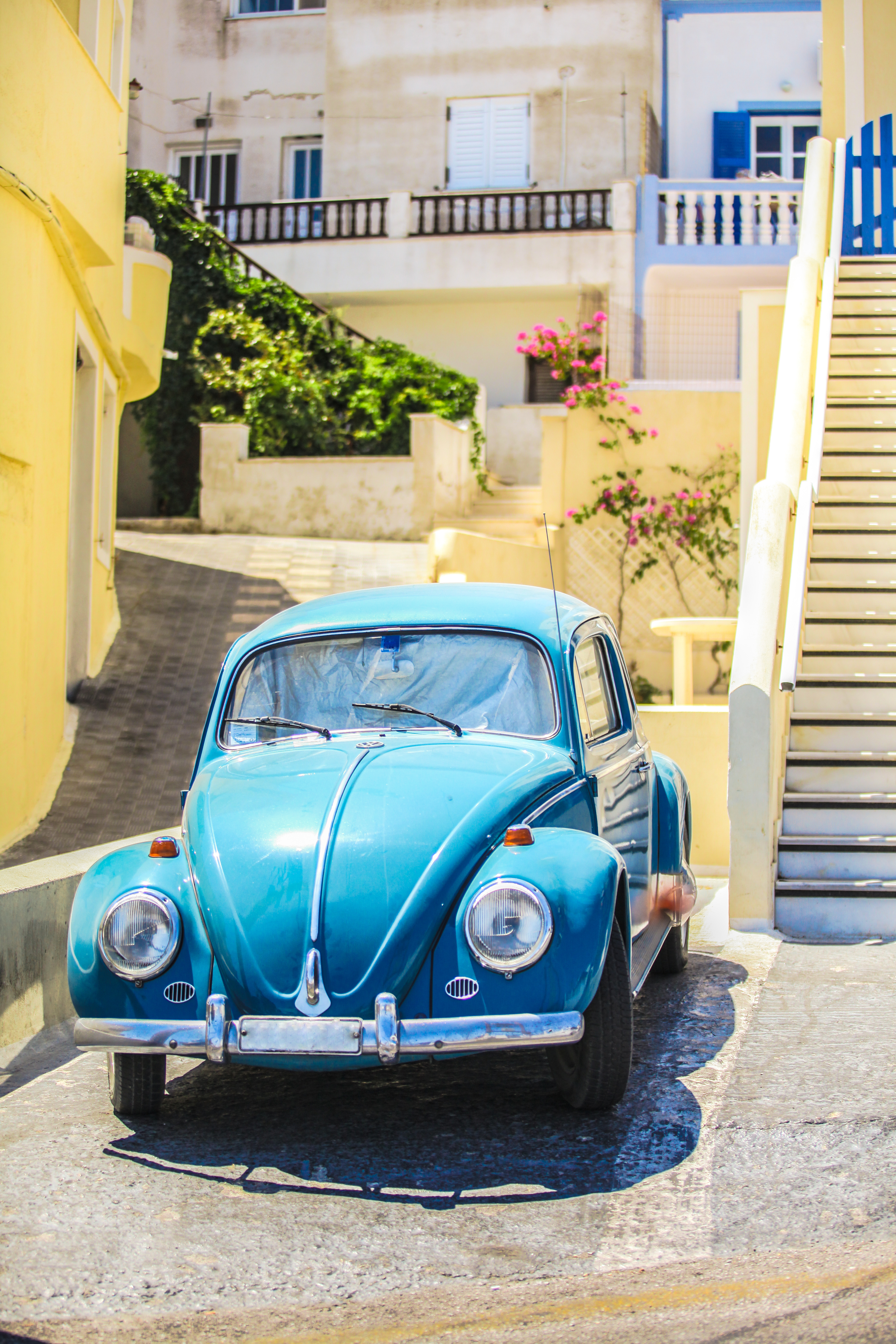 close-up of blue car in the courtyard of greek house on Santorini